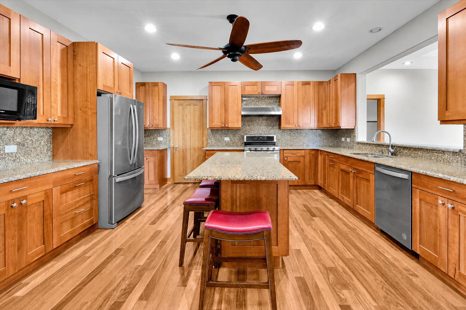 Kitchen with granite island and custom cabinetry