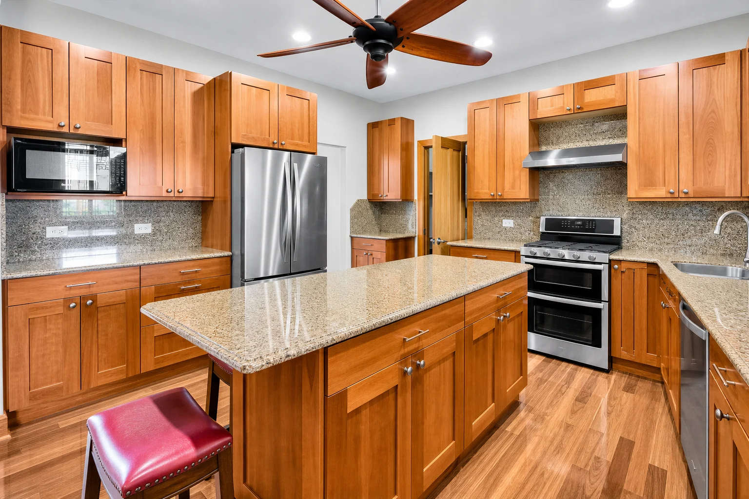 Kitchen with granite island and custom cabinetry